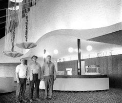 Three men stand in front of a curved concession stand.  Three waterfall chandeliers are visible in the top right. - , Utah